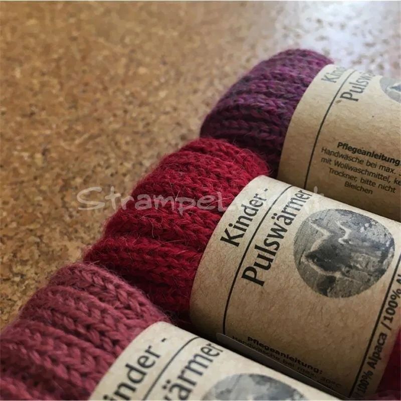 De Colores Kinder Pulswärmer aus Alpakawolle rot/orange/lila Töne